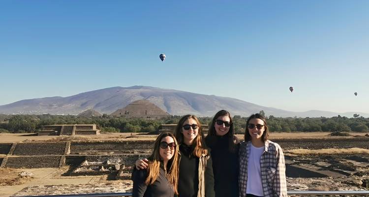 Vier Freunde mit Heißluftballons und Bergkulisse in Teotihuacán.