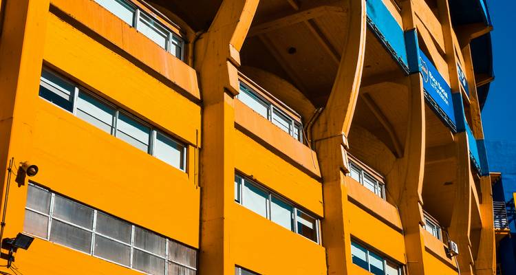 Close angled view of bright yellow building columns and windows in Buenos Aires.