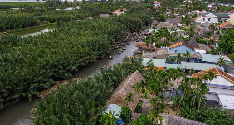 Aerial shot of coconut-lined waterways and villages near Hoi An’s palm river forest.