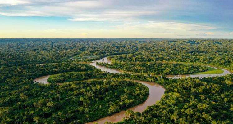 Another aerial view of a serpentine river cutting through endless green jungle.