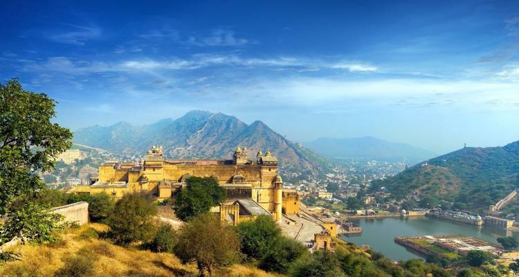 Panoramic view over Amber Fort and surrounding hills with a lake and Jaipur city below