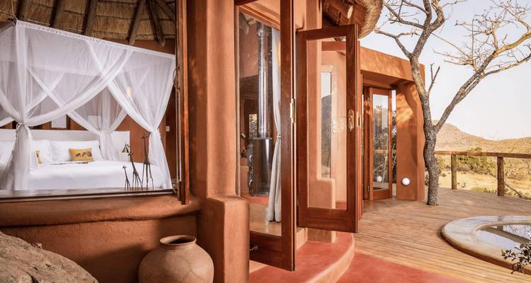 Elegant safari suite opening to a private deck with a plunge pool and scenic bush views