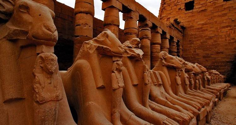 Row of ram-headed sphinx statues lining the entrance of Karnak Temple