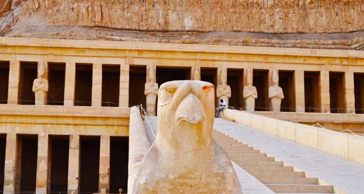 Falcon-headed statue in front of Hatshepsut’s Temple with colonnaded facade in the background