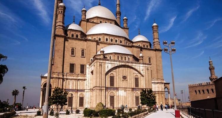Impressive Muhammad Ali Mosque with white domes against a bright blue sky