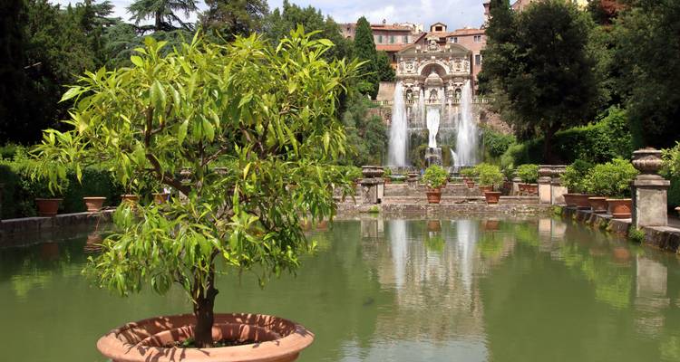 Elegant fountains of Villa d'Este cascade into a reflective pool within lush gardens.