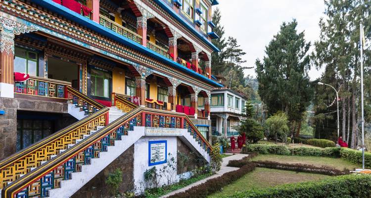Colorful multi-storey Buddhist monastery with ornate painted staircases.