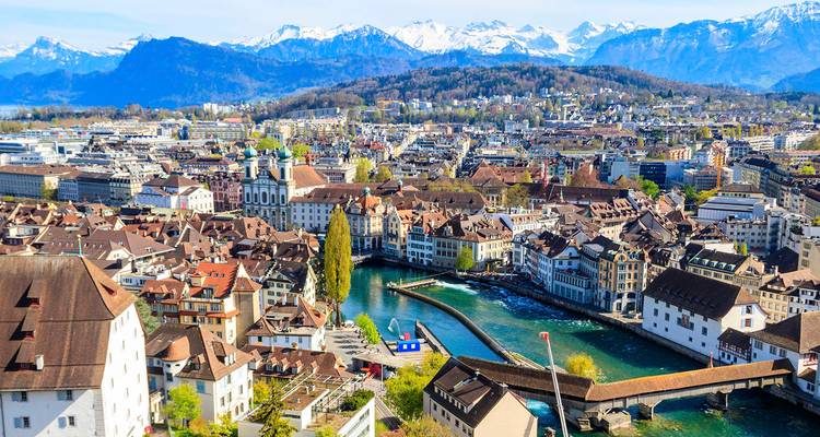 Aerial panorama of Lucerne’s old town, lake and snow-capped Alps in the background on a clear day.
