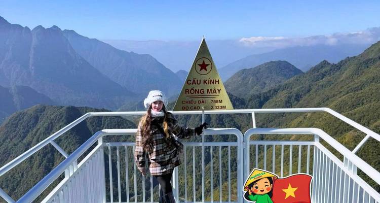 Traveler posing on glass bridge viewpoint with triangle summit sign and cartoon overlay.