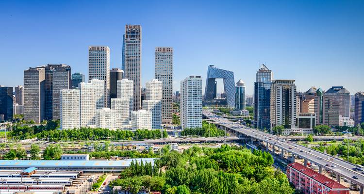 Clear day panorama of Beijing CBD with multilane elevated road and skyscrapers against blue sky
