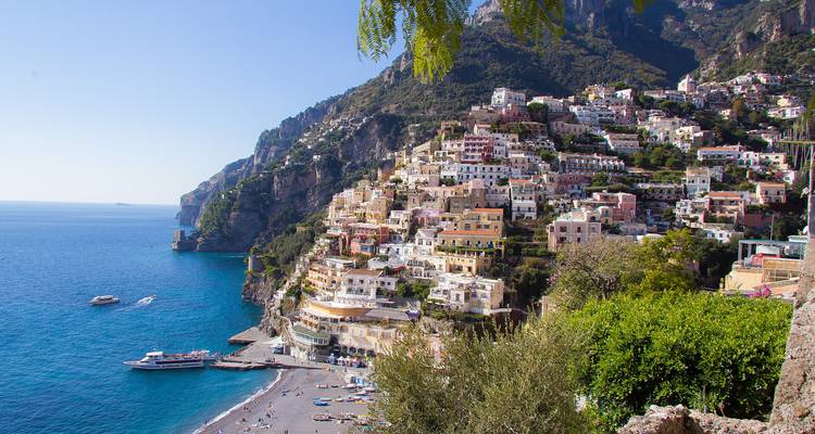 Clifftop cascade of pastel homes in Positano overlooking crystal-blue waters of the Amalfi Coast.