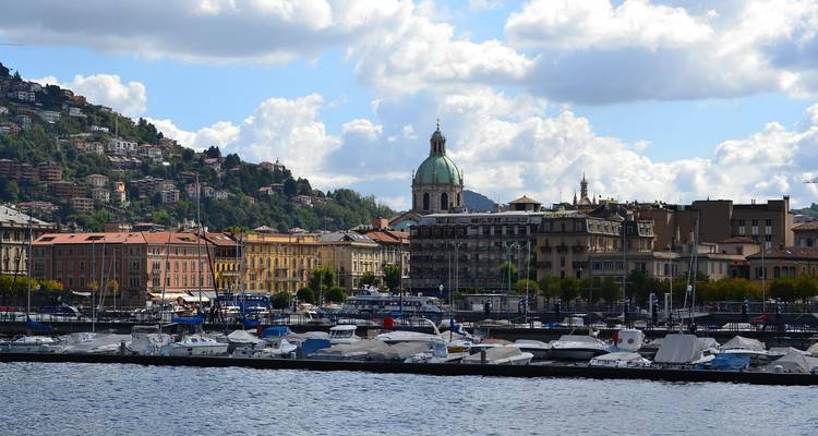 Historic lakeside city with domed cathedral and marina full of boats