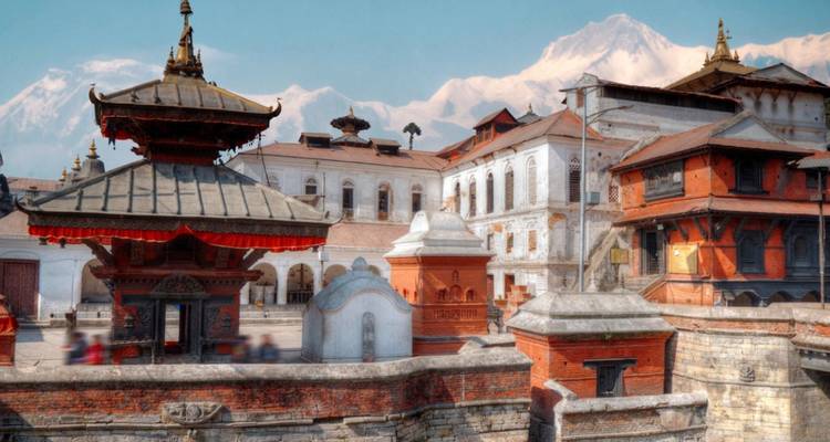 Historic Kathmandu Durbar Square with snow-capped peaks faintly visible in the background.