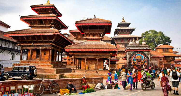 Bustling Kathmandu Durbar Square with tiered temples, street vendors and locals.