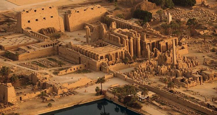 Aerial photograph of the vast Karnak Temple complex with surrounding ruins and sacred lake