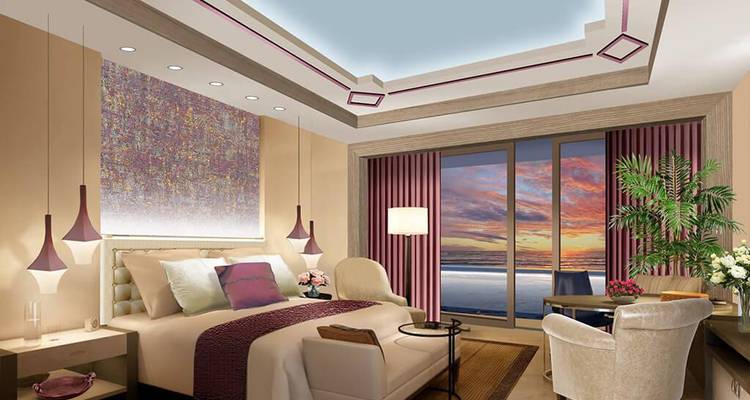 Stylish hotel suite with modern lighting and ocean-sunset view.