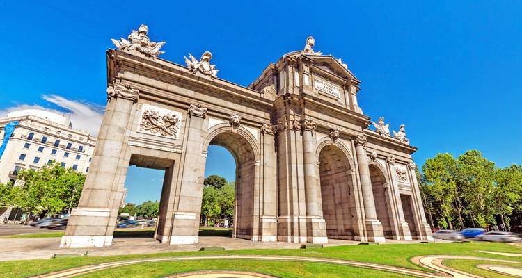 Puerta de Alcalá aus einem seitlichen Blickwinkel vor einem leuchtend blauen Himmel fotografiert