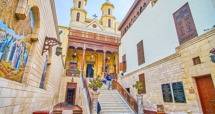Exterior staircase leading to the Hanging Church complex with visitors on the steps.