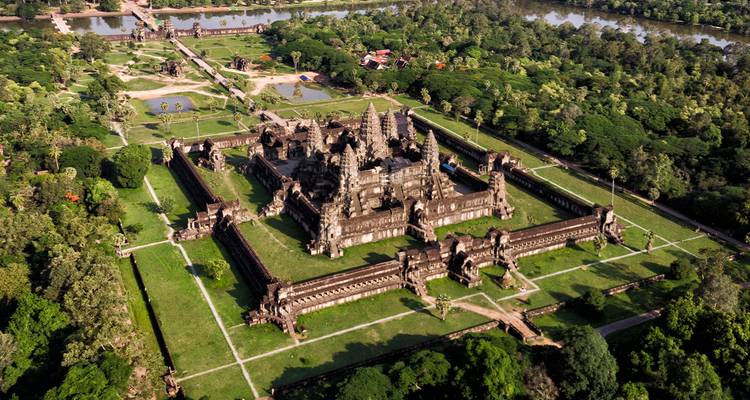 Aerial view of the sprawling temple complex of Angkor Wat surrounded by jungle and moats.