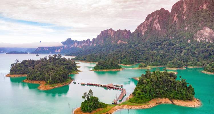 Aerial view of emerald lakes, rainforest-covered islands and dramatic limestone mountains