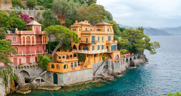 Brightly painted villas cascading down rocky terraces into the turquoise Ligurian Sea near Portofino.