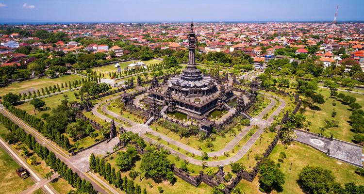 Drone shot of the Bajra Sandhi Monument surrounded by manicured lawns in the centre of Denpasar.