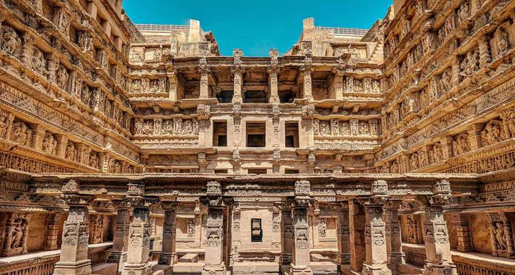 Intricately carved pillars and galleries of the Rani ki Vav stepwell bathed in sunlight.