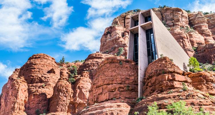 The modern Chapel of the Holy Cross is built into towering red sandstone formations.