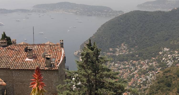 Elevated coastal view across terracotta rooftops and turquoise bays from the gardens of Eze