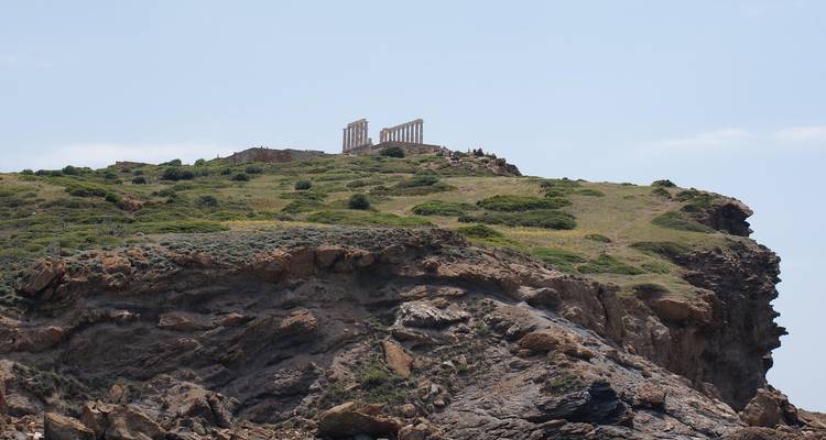 Temple of Poseidon ruins standing on a rugged coastal cliff top against the sky