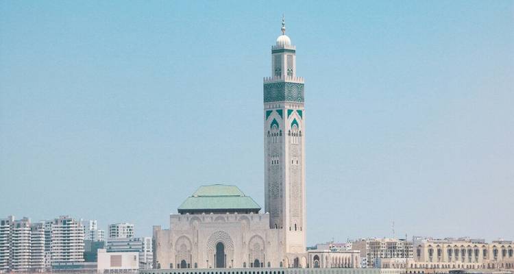 Hassan II Mosque with its towering minaret standing against a clear blue sky along the Casablanca waterfront