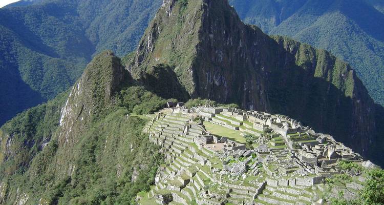 Iconic aerial perspective of Machu Picchu’s stone terraces nestled among steep green Andean peaks.