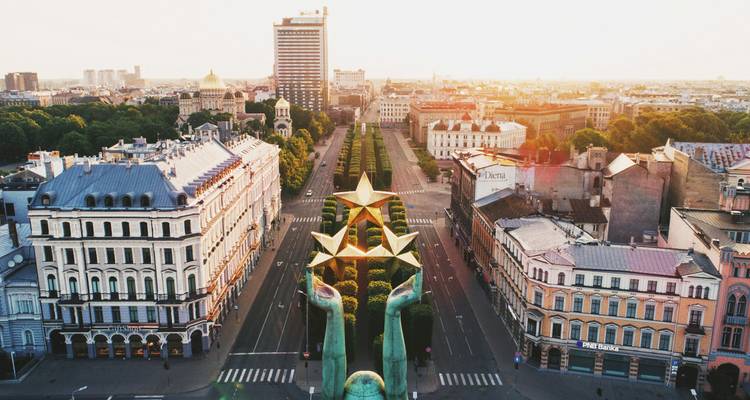 Luftperspektive des Freiheitsdenkmals von Riga mit baumbestandener Promenade bei Sonnenaufgang