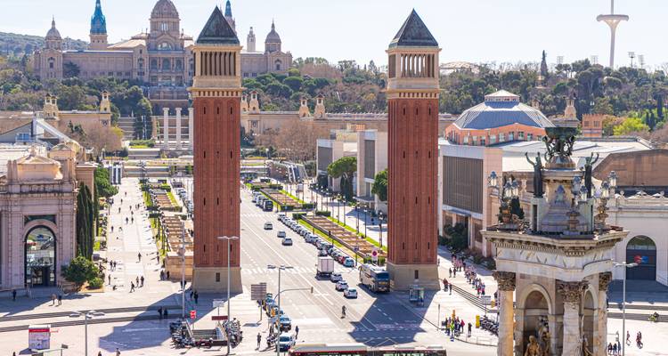 Panoramic view of Barcelona’s Plaça d’Espanya featuring twin Venetian towers and the National Art Museum in the distance
