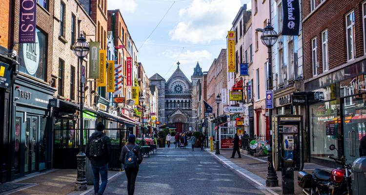 Vibrant pedestrian shopping street in central Dublin lined with pubs, shops and colourful signage.