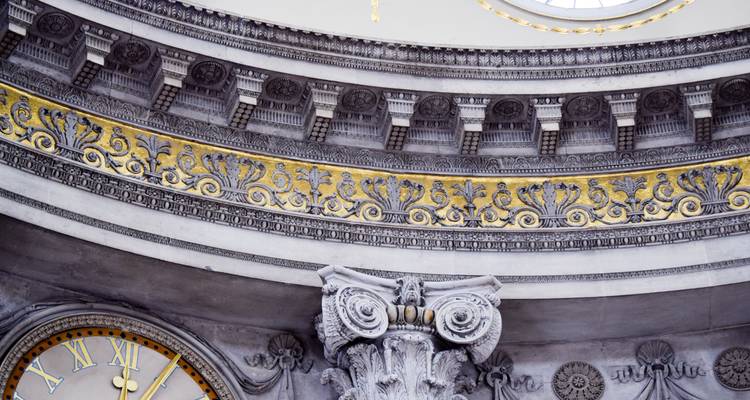 Detailed interior shot of ornate column and gilded frieze inside a historic Dublin building.