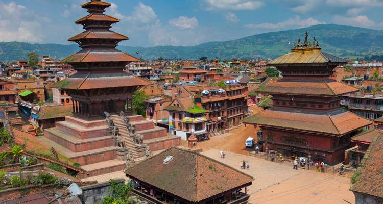 Elevated view of Kathmandu Valley's Bhaktapur Durbar Square with tiered pagoda temples and surrounding town.