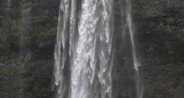 Close-cropped dark image of waterfall with motion blur