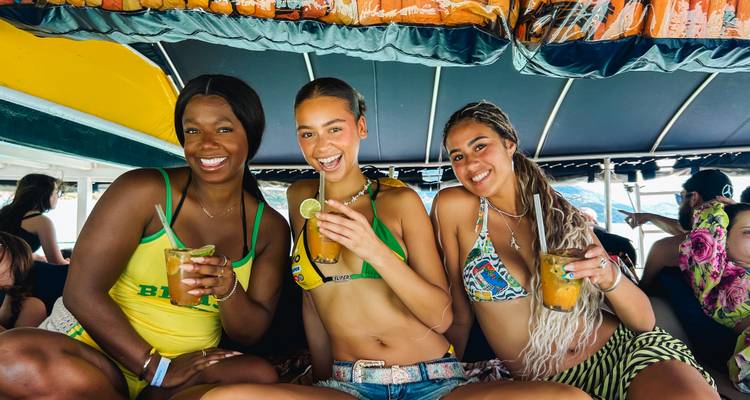 Young women in swimwear enjoying cocktails on a boat in Brazil.