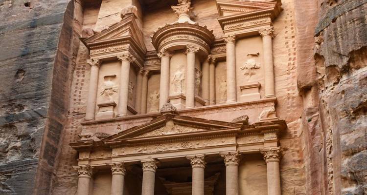 Detailed view of Petra's ornate Treasury carved into rose-red rock