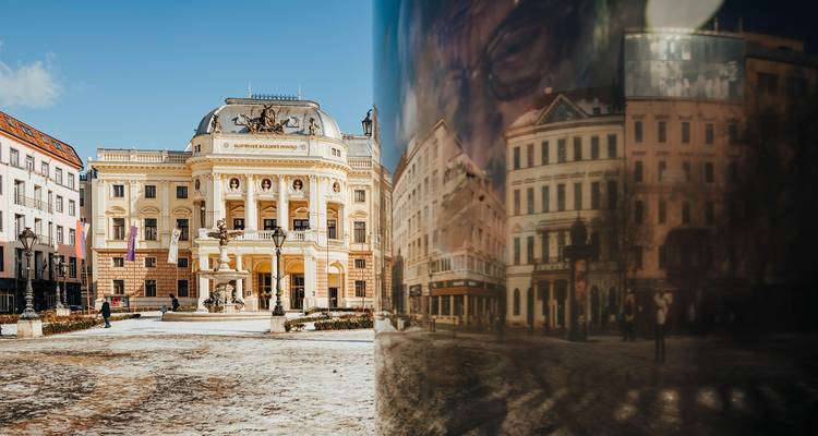Teatro de gran estilo neo-renacentista que da a una plaza soleada, reflejado creativamente en una superficie pulida.