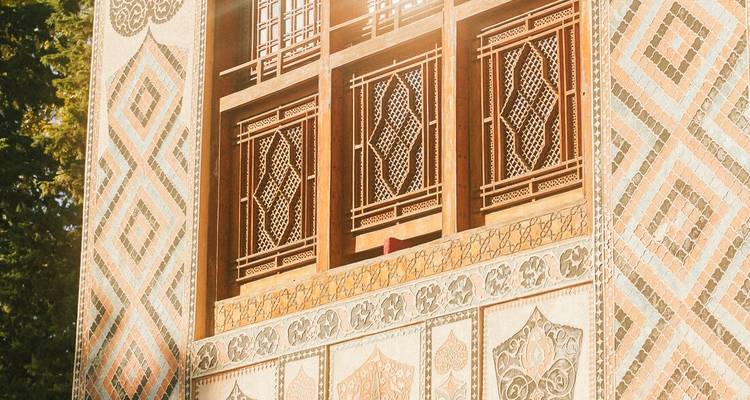 Sun-lit detail of the intricate mosaic and wooden lattice windows of Sheki Khan's Palace.