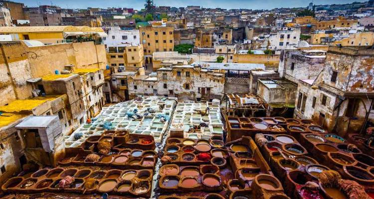 A panoramic view over Fes’ sprawling leather tanneries shows colourful dye pits amid old medina rooftops.