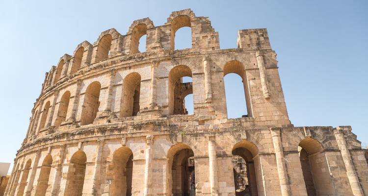 Close view of the massive stone arches of the ancient Roman amphitheatre of El Jem