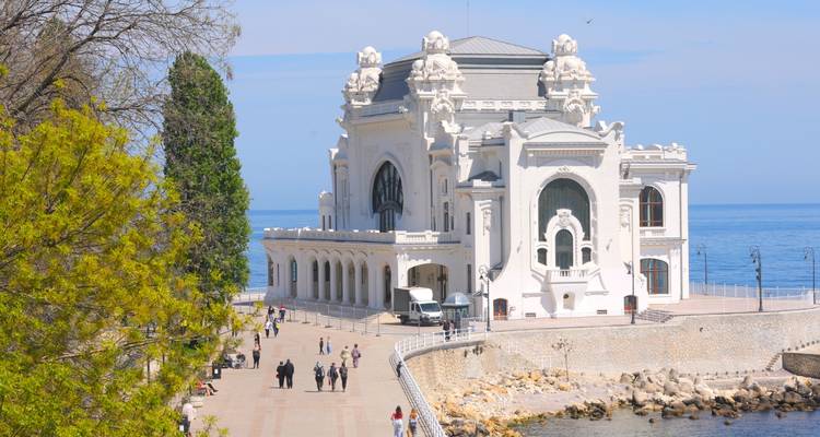 Seaside promenade leading to the ornate Constanta Casino overlooking the Black Sea.