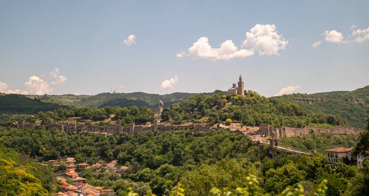 Panoramic view of Veliko Tarnovo’s hilltop fortress surrounded by lush green valleys.