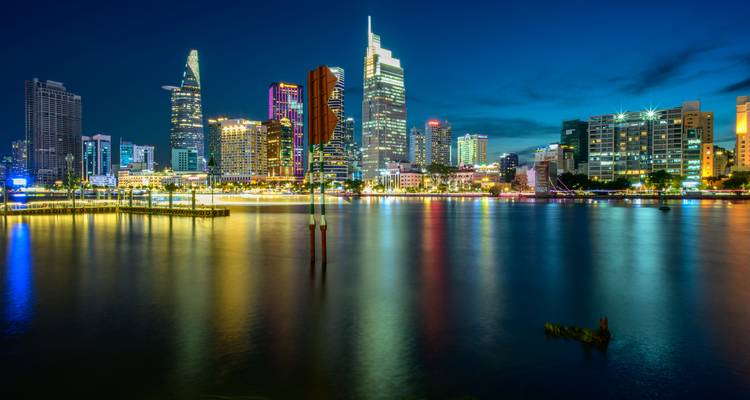 Blue hour long-exposure of Ho Chi Minh City skyline reflected in the Saigon River