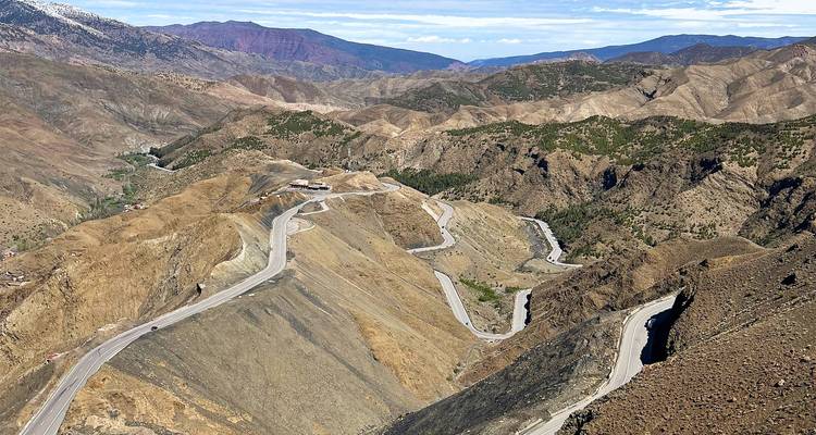 Aerial view of winding mountain highway through arid High Atlas landscape