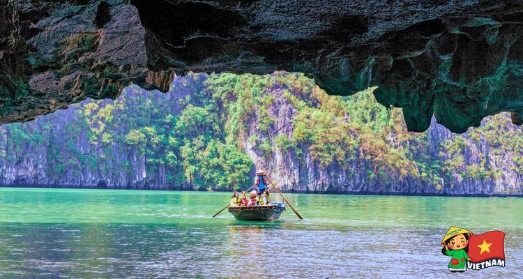 Rowboat passes beneath a dramatic cave opening on jade waters framed by Halong Bay cliffs.