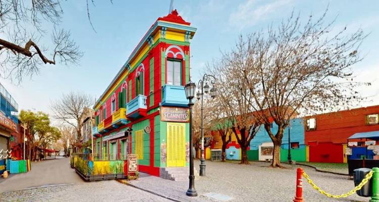 Iconic bright-painted corner building on a cobblestone street in Buenos Aires’ Caminito.